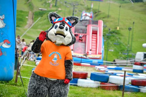 a person in a mascot costume standing in a park at Chalet Everest - Luxury Apartments in Prato Nevoso
