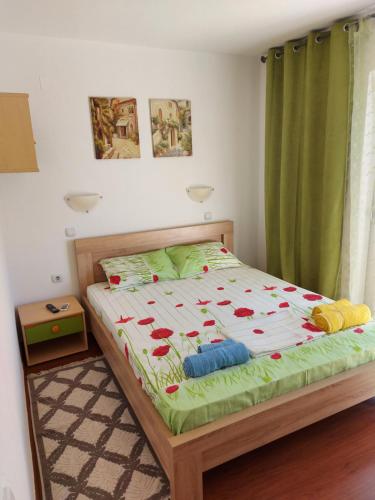 a bedroom with a bed with red hearts on it at Villa Lyudmila in Utjeha
