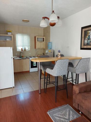 a kitchen with a table and chairs in a room at Villa Lyudmila in Utjeha
