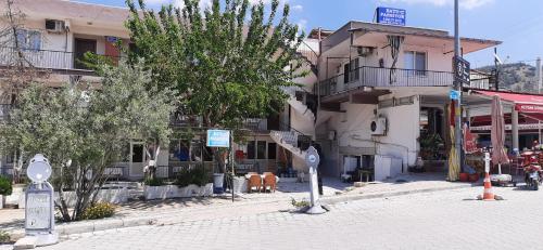 a city street with buildings and trees and parking meters at Pamukkale Batu Termal in Pamukkale