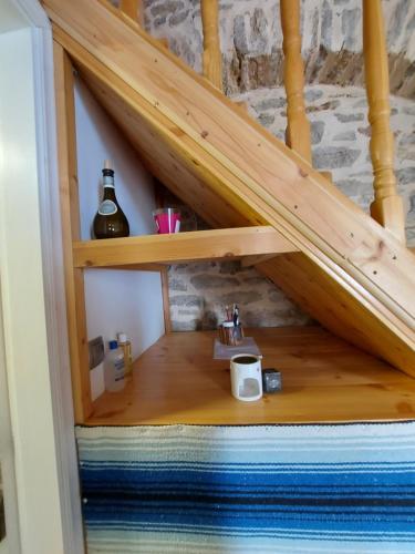 a shelf under a staircase with a coffee maker on it at Ήλιος Πατσακης in Symi