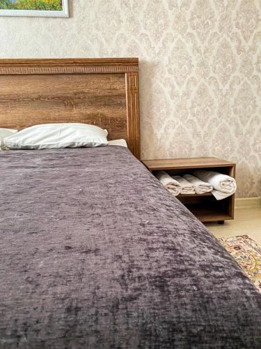 a bedroom with a large bed with a pillow at AL BARAKA in Borovoye