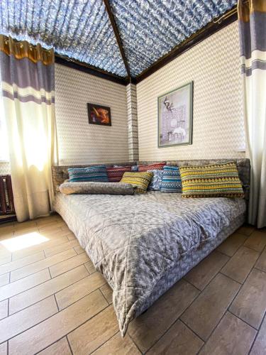 a bed with pillows on it in a room at AL BARAKA in Borovoye