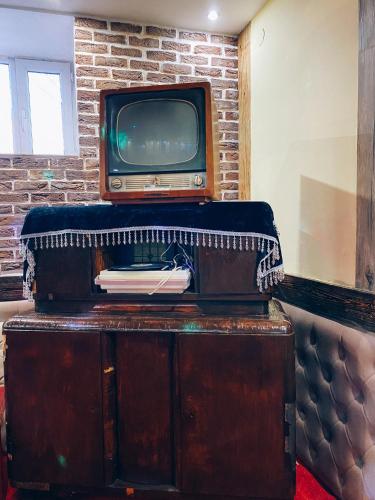 an old television sitting on top of a wooden cabinet at AL BARAKA in Borovoye