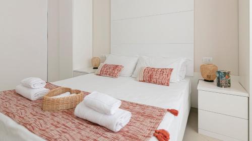a white bedroom with a bed with towels on it at Residenza Excelsior in Vasto