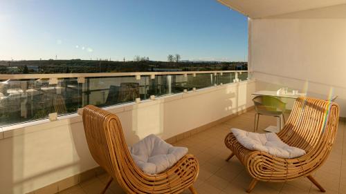 a balcony with two rattan chairs and a table at Residenza Excelsior in Vasto