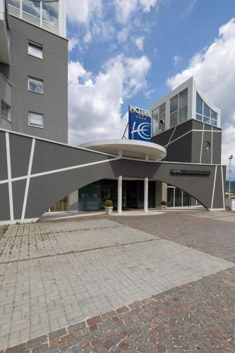 a building with a sign on the side of it at Hotel Europa Belluno in Belluno