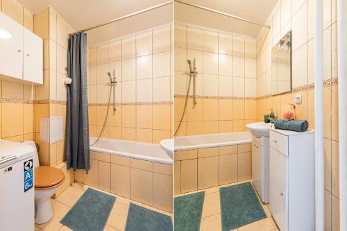 a bathroom with a tub and a toilet and a sink at SuperApart Łukowa 2 in Warsaw