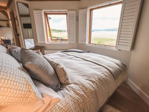 A bed or beds in a room at Oversands Cottage