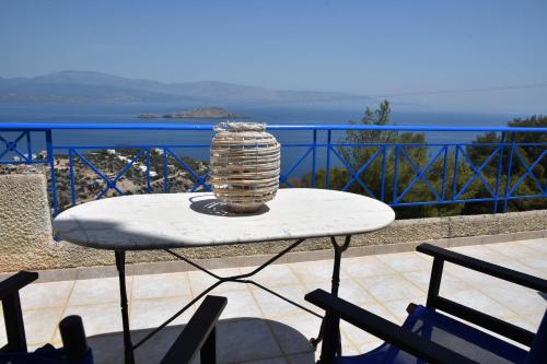 a table on a balcony with a view of the ocean at Villa Iokasti (sea view) in Pefkali