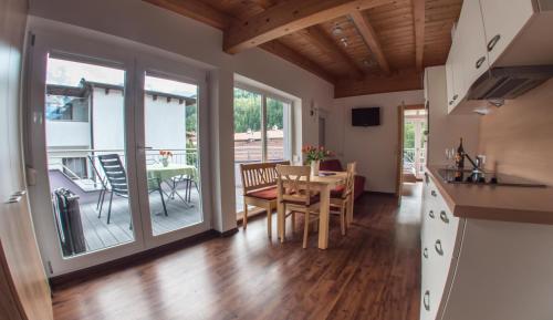 a kitchen and dining room with a table and chairs at Alpenapart Saphir in Sölden