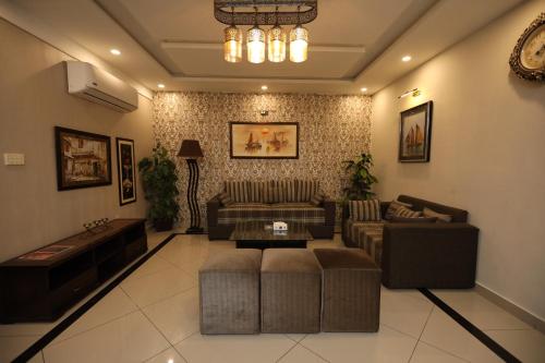 a living room with couches and a coffee table at Safari Club 4 in Rawalpindi
