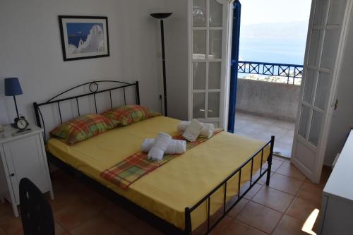a bedroom with a bed with two teddy bears on it at Villa Iokasti (sea view) in Pefkali