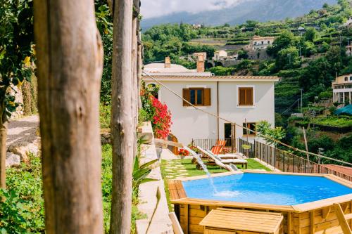 a villa with a swimming pool and a house at Villa Le Murelle in Tramonti