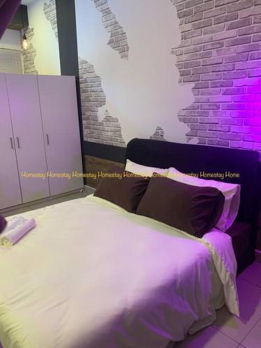 a bedroom with a white bed with purple lighting at Couples Mind Relaxing Holiday Paradise 11 in Cyberjaya