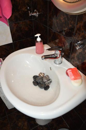 a white sink with rocks in the middle of it at Villa Iokasti (sea view) in Pefkali
