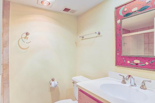 a bathroom with a sink and a mirror at Night Heron 35 in Hilton Head Island