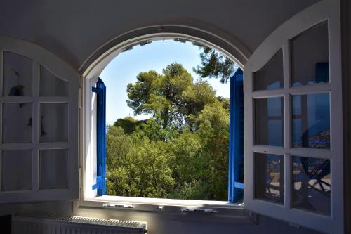 an open window with a view of a tree at Villa Iokasti (sea view) in Pefkali