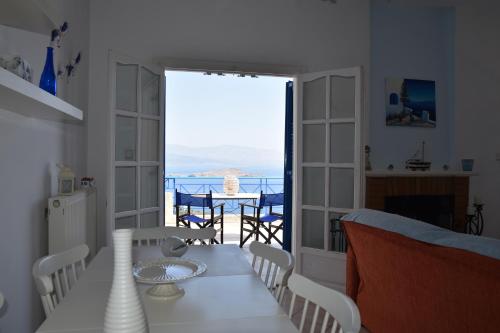 a dining room with a table and a view of the ocean at Villa Iokasti (sea view) in Pefkali