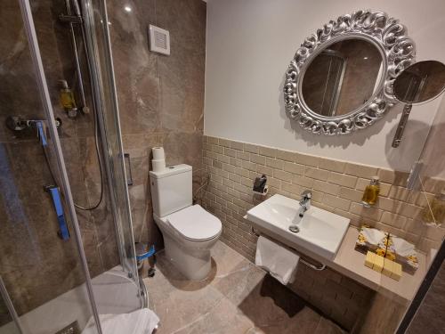 a bathroom with a toilet, sink, and shower at Apartment Residence - FREE PARKING in Bratislava