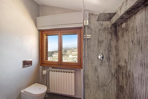 a bathroom with a toilet and a window at Villa Gaia in Bordighera