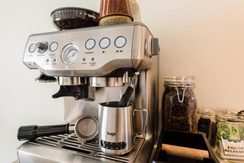 a coffee machine sitting on top of a stove at Van Heeckeren Apartments & Suites Nes in Nes