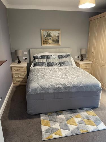 a bedroom with a large bed and two night stands at Simon’s Seat View in Skipton