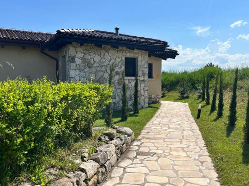 a stone path in front of a house with trees at Private Villa at BlackSeaRama Golf & Villas Resort in Balchik
