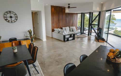 a living room with tables and chairs and a couch at Casa Nina Santa Teresa in Santa Teresa Beach