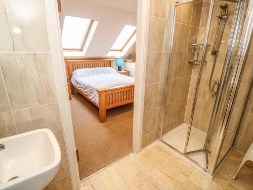 a bathroom with a shower and a sink at Sunswept in St Austell