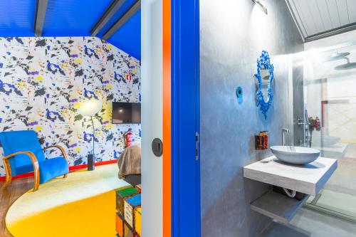 a bathroom with a sink and a wall covered in magnets at Moinho d'Antoninha in Leomil