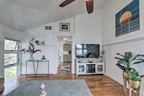 a living room with white walls and a flat screen tv at Serene Cape Cod Escape with Private Ocean Overlook! in Mashpee