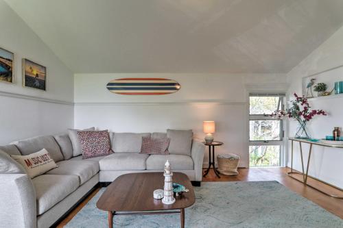 a living room with a couch and a table at Serene Cape Cod Escape with Private Ocean Overlook! in Mashpee