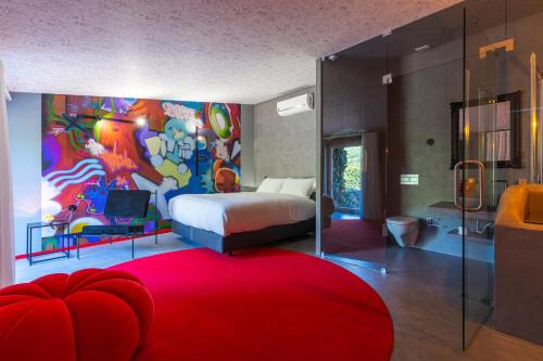 a bedroom with a bed with a painting on the wall at Moinho d'Antoninha in Leomil