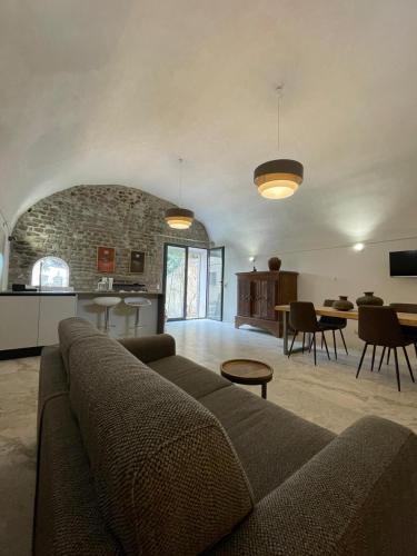 a living room with a couch and a kitchen at Agriturismo Castello Santa Margherita in Cori
