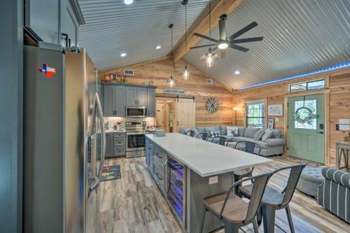 a kitchen and living room in a log cabin at Lakewood Secret Cabin about 4 Mi to The Lake! in Canyon Lake