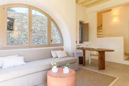 a living room with a couch and a table at Camarades Mykonos in Ano Mera