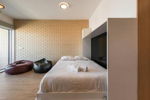 a bedroom with a bed with two dogs laying on it at Dragon Stadium Studio w Balcony by LovelyStay in Porto