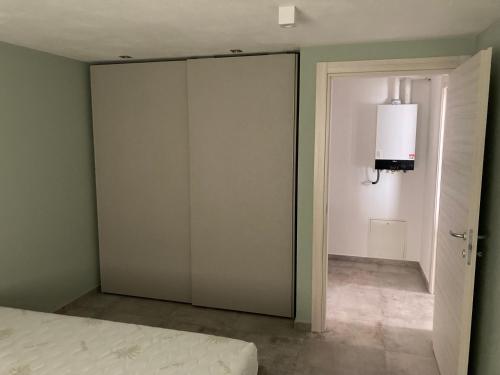 a bedroom with a sliding glass door and a bed at Senin House in Aosta
