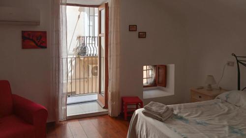 una camera da letto con un letto e una finestra aperta di Casa vacanza U Curtigghiu a Città di Lipari
