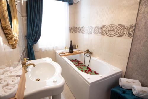 a bathroom with a tub and a toilet and a sink at Bükki Villa in Bükkszék