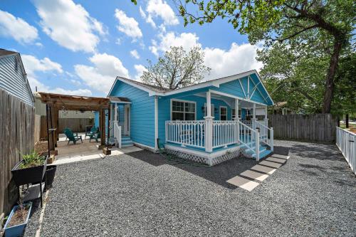 a blue house with a porch and a fence at Blue Bungalow In Houston Heights! Walkable to Popular Bars in Houston