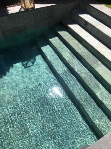 a pool of water with some stairs in it at Palacio Condes de Cirac in Villalba de Rioja
