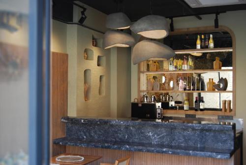 a bar in a restaurant with a counter and pendant lights at Four Sides Beyoglu in Istanbul