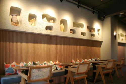 a dining room with tables and chairs and a wall with holes at Four Sides Beyoglu in Istanbul