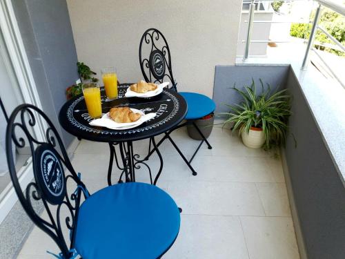 a table with plates of food on a balcony at Orchid SeaView Apartment With Garage Parking in Zaton