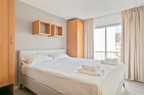 Ένα ή περισσότερα κρεβάτια σε δωμάτιο στο Apartamentos Barcarola