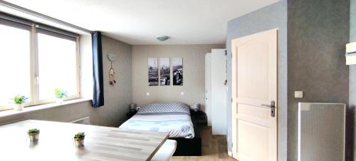 a small bedroom with a bed and a window at La Maison Alsacienne in Kintzheim