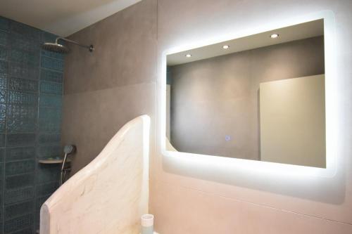 a bathroom with a large mirror on the wall at Nesea in Psérimos