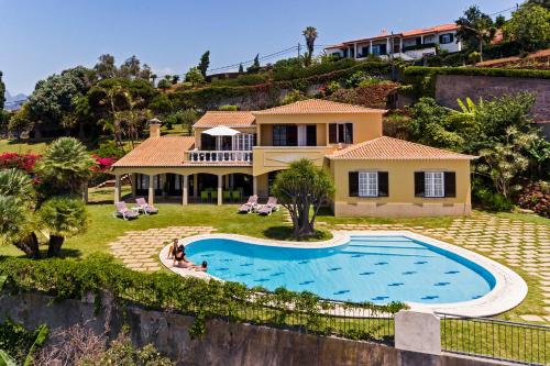 an aerial view of a house with a swimming pool at Vila Eucalipto by An Island Apart in Funchal